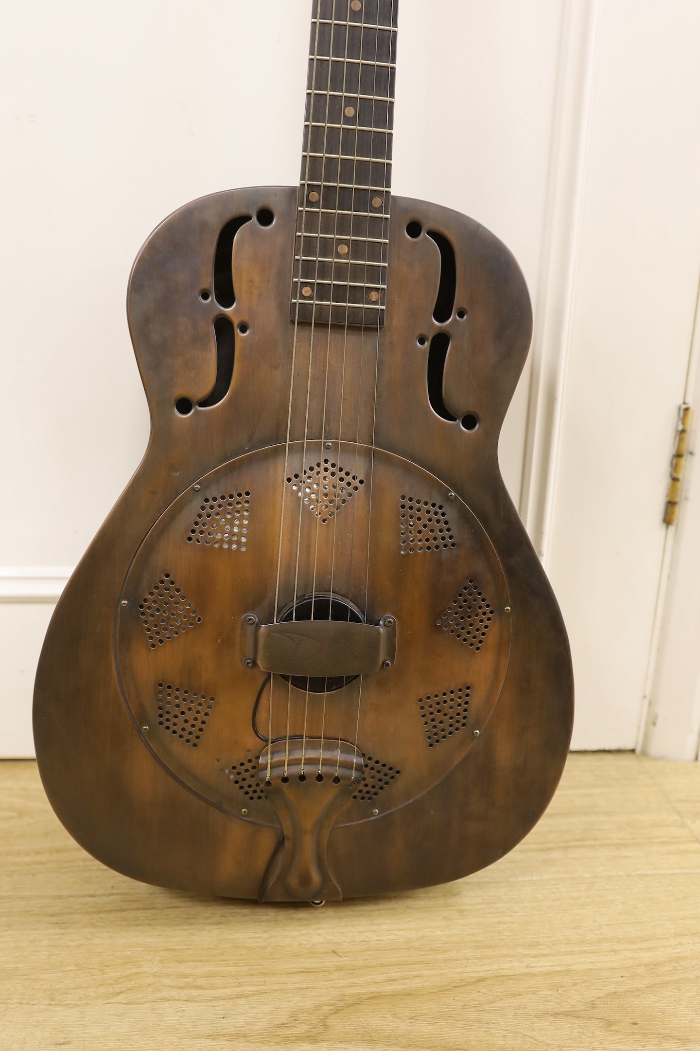 A Dean Resonator Heirloom guitar, bronzed finish, with soft case, 100cms high.